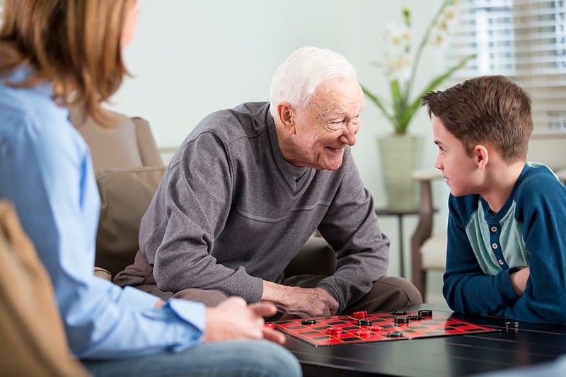 grandfather and grandson playing checkers